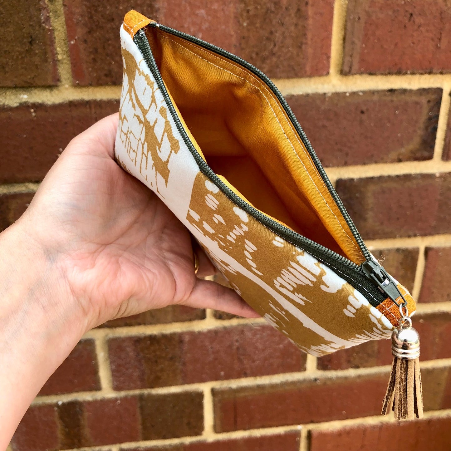 Mustard Yellow Abstract lined zipper pouch with tassel